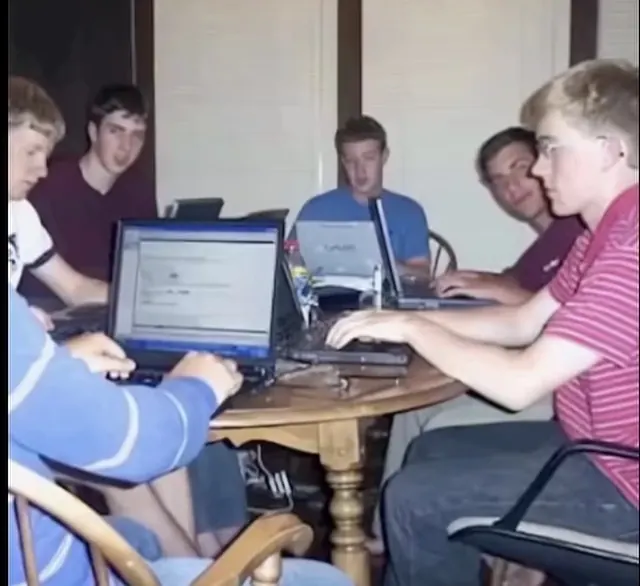 mark zuckerberg and friends coding in a dorm room